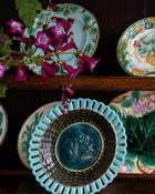 Decorative plates with floral patterns and a central relief design on a dark background.