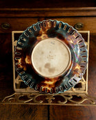 Decorative plate with a tortoiseshell pattern on a wooden surface
