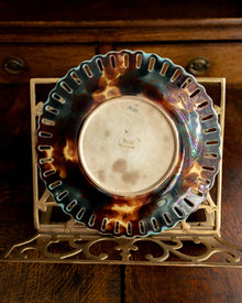 Decorative plate with a tortoiseshell pattern on a wooden surface