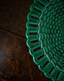 Close-up of a green woven mat on a wooden surface