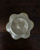 Ceramic oyster plate on a wooden surface with labels on a wooden surface