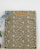 Floral patterned sampler with a brown label on a white background