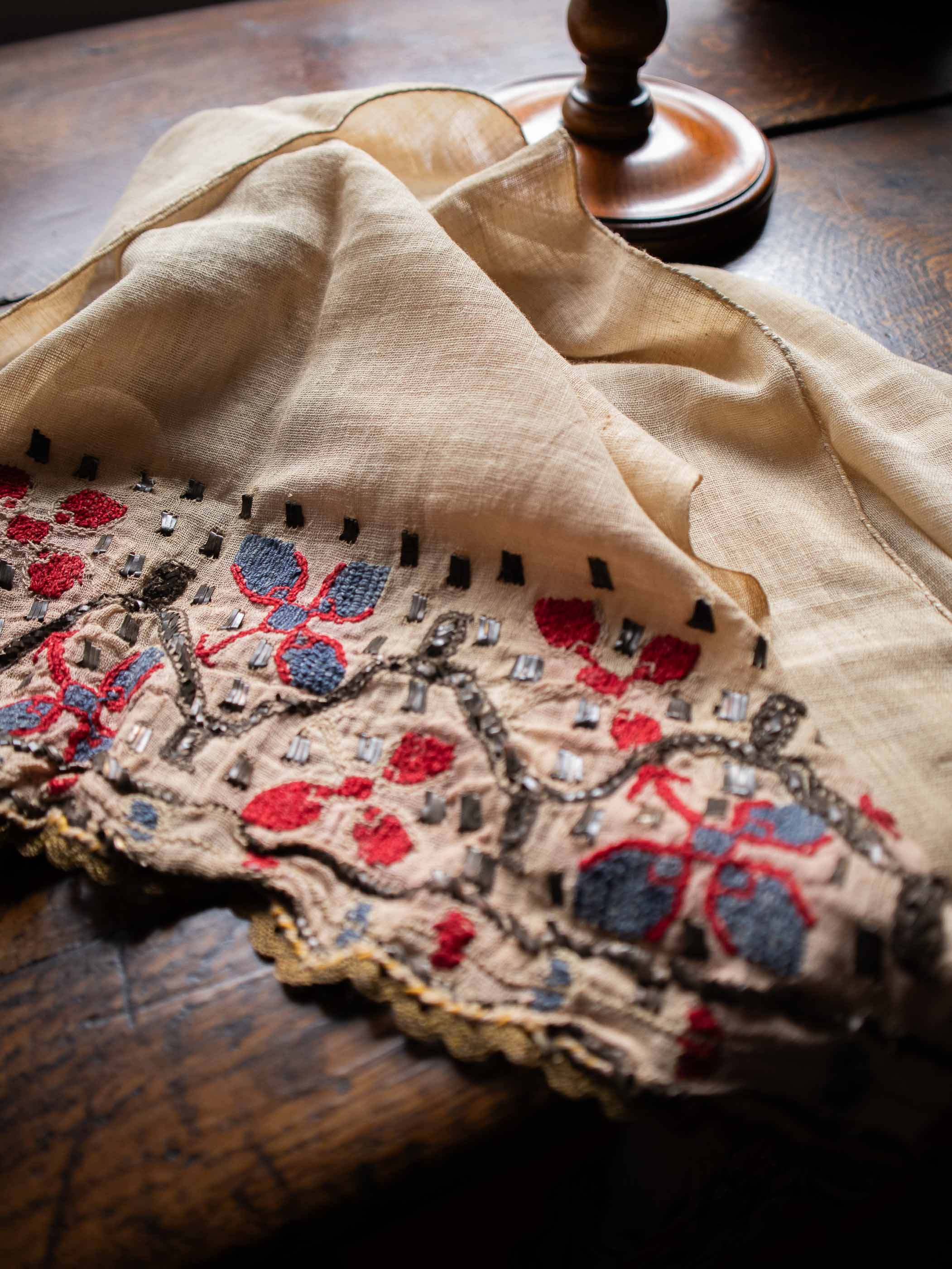 Embroidered fabric with floral patterns on a wooden surface