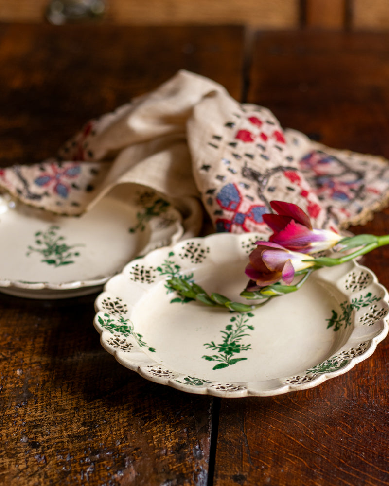 Decorative ceramic plate with floral design on a wooden surface
