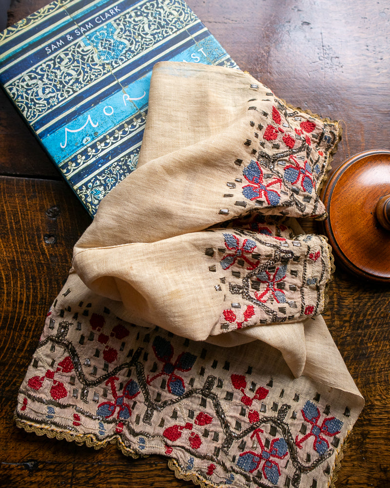 Embroidered turkish cloth with floral patterns on a wooden surface
