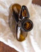 Brown glass bottle on a white cloth surface