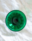 Green glass object on a white surface