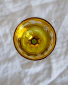 Yellow glass object on a white fabric background