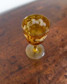 Decorative glass with a drink on a wooden surface