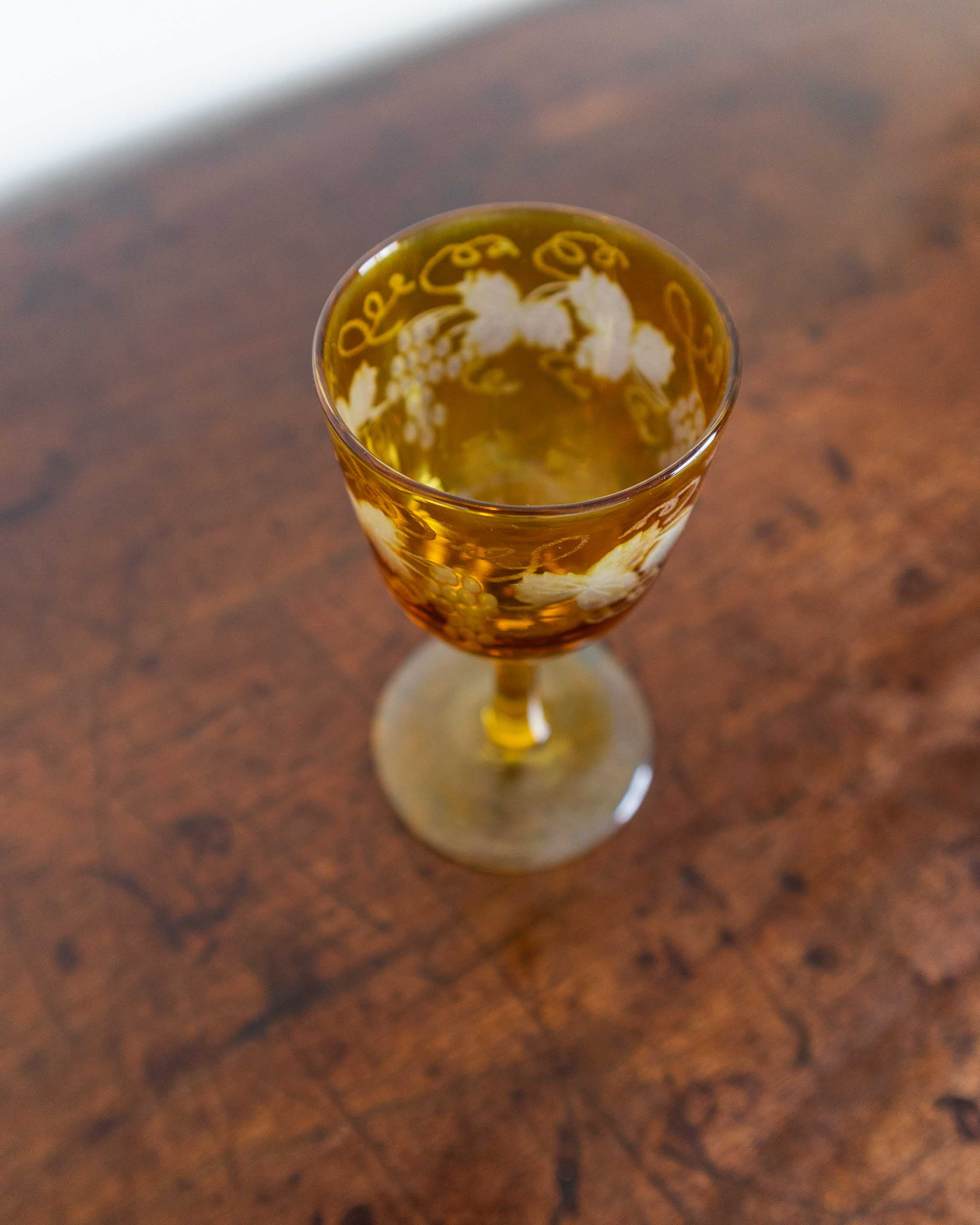 Decorative glass with a drink on a wooden surface