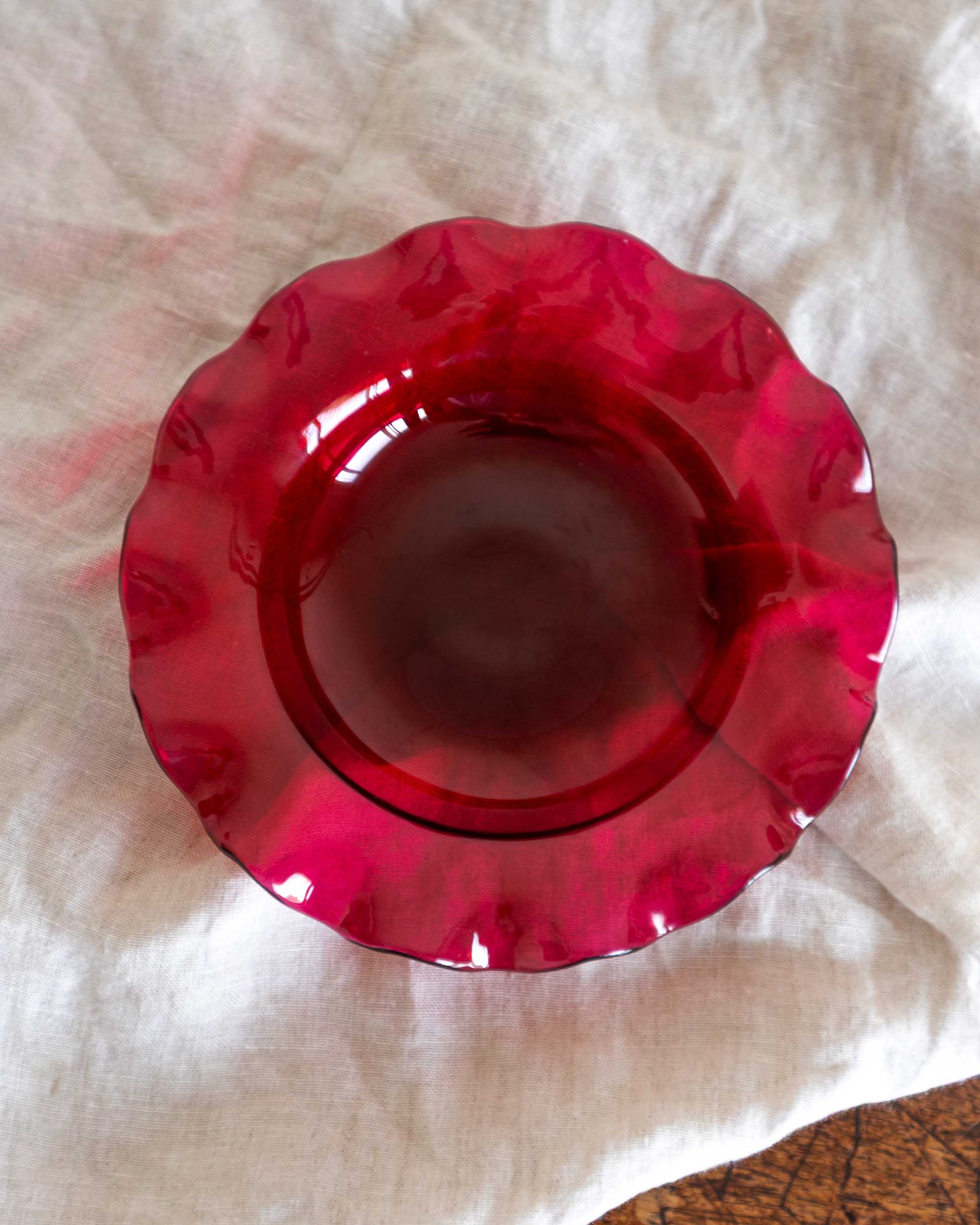 Red glass bowl on a white cloth
