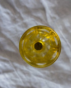 Yellow glass on a textured grey background