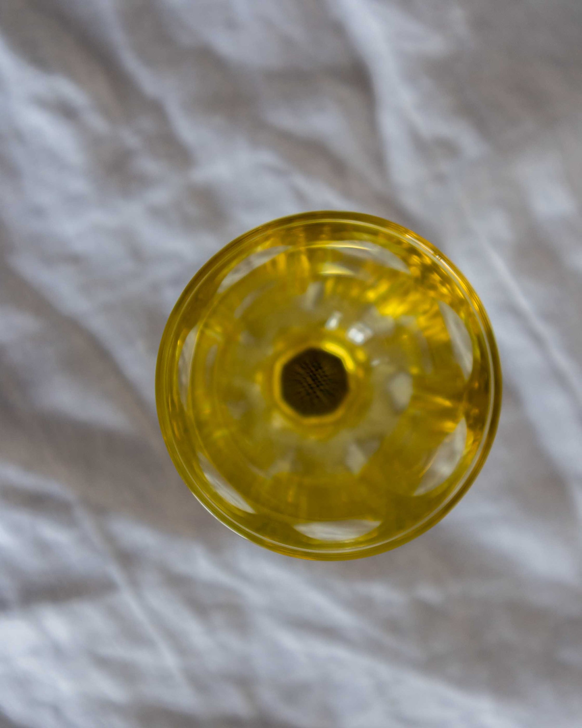 Yellow glass on a textured grey background