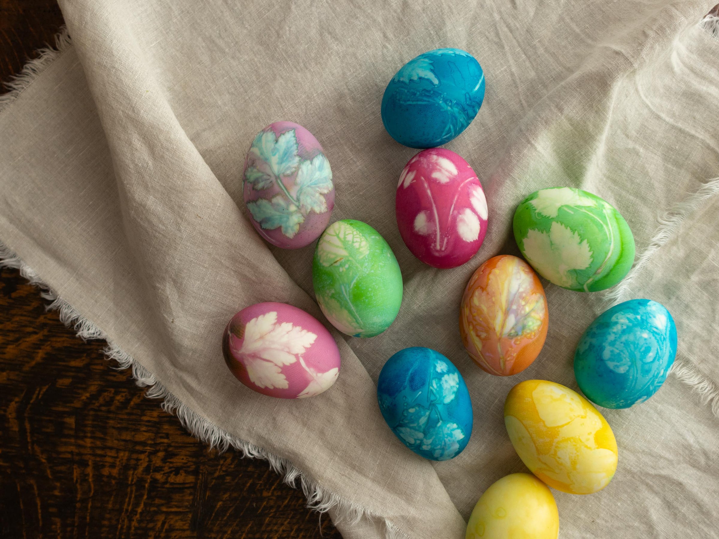 Colorful Easter eggs with floral patterns on a textured fabric background