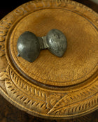 Lemon pewter ice cream mould on wooden breadboard with a dark background