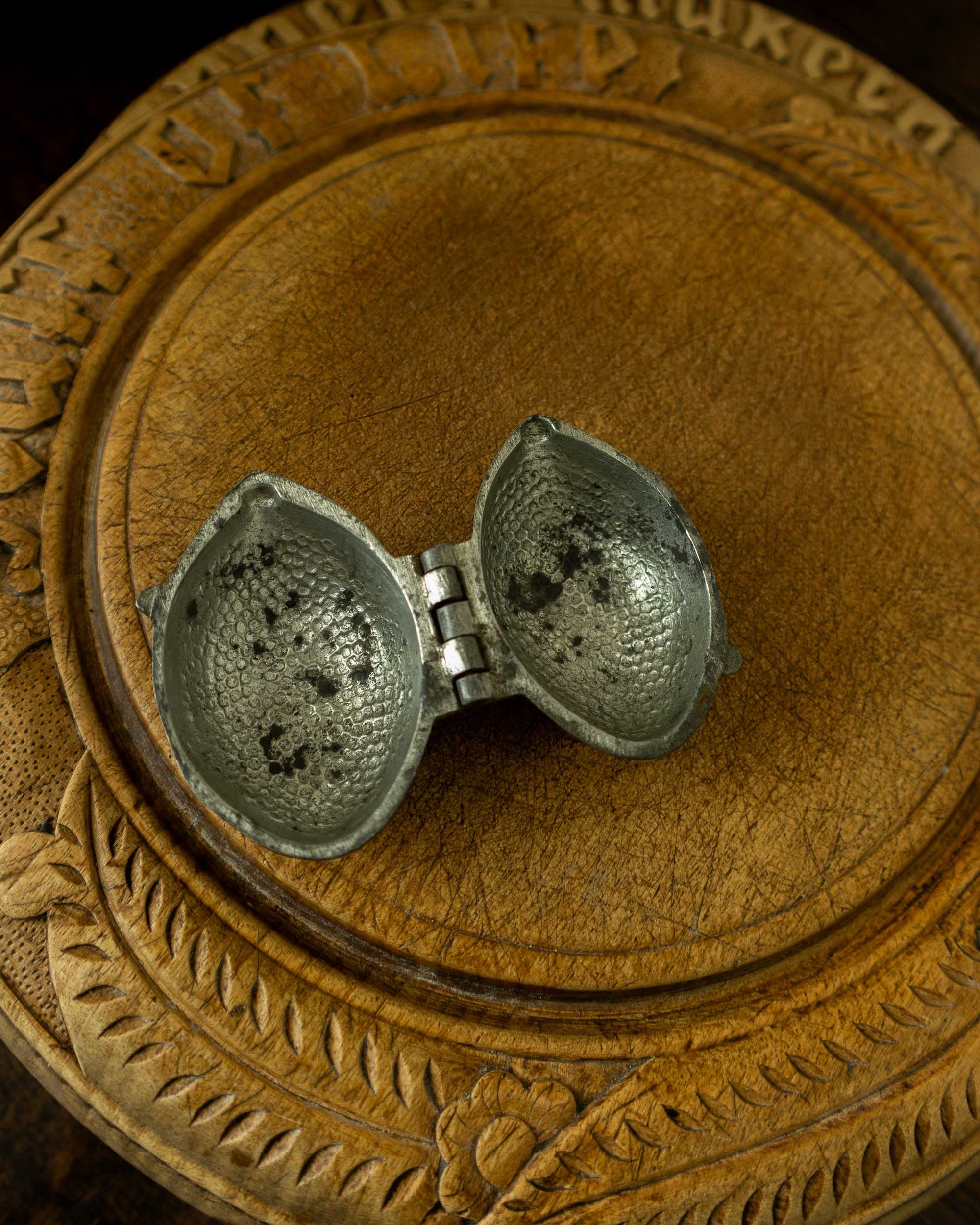 Lemon pewter ice cream mould on wooden breadboard with a dark background