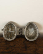 Walnut pewter ice cream mould on wooden surface