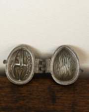 Walnut pewter ice cream mould on wooden surface
