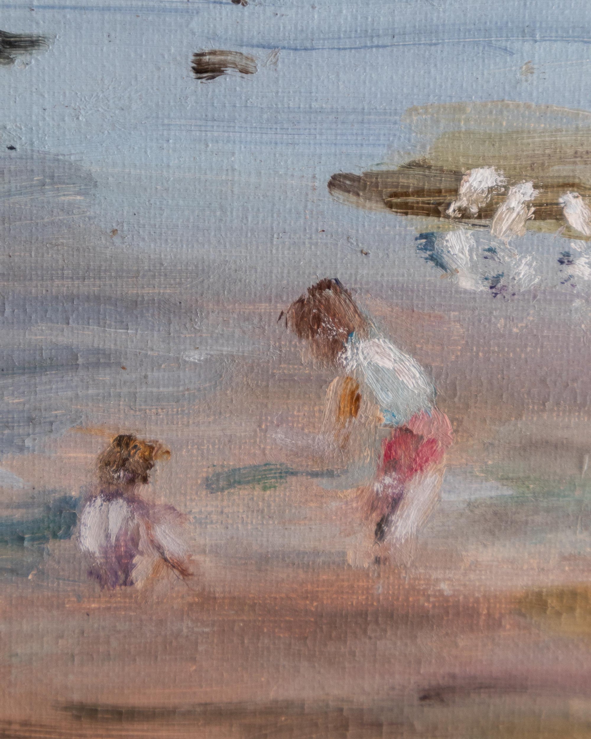 Framed painting of a beach scene with two children and seagulls.