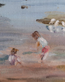 Framed painting of a beach scene with two children and seagulls.