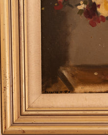 Close-up of a painting with a gold frame, showing the edge of the artwork.