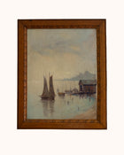 Framed painting of a harbor scene with sailboats and a wooden cabin.