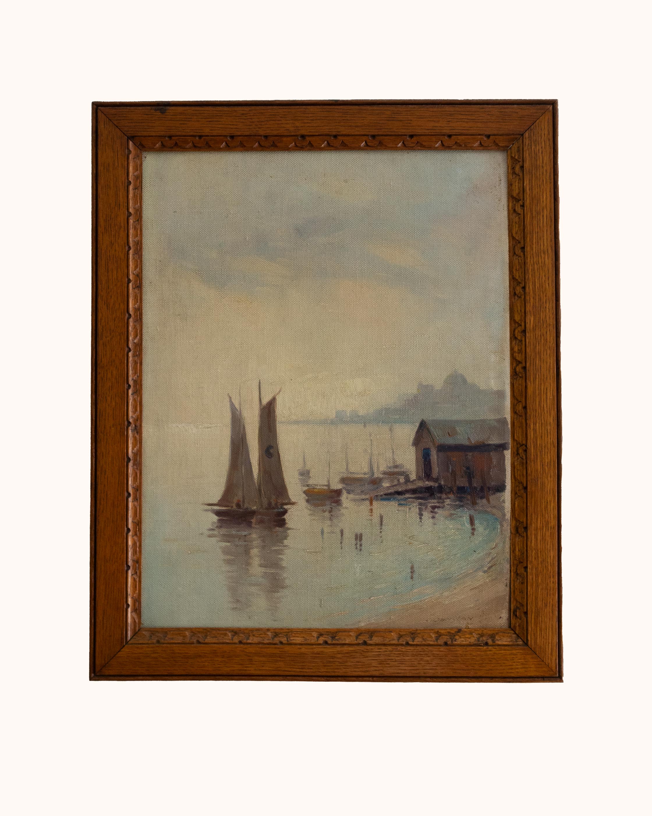 Framed painting of a harbor scene with sailboats and a wooden cabin.