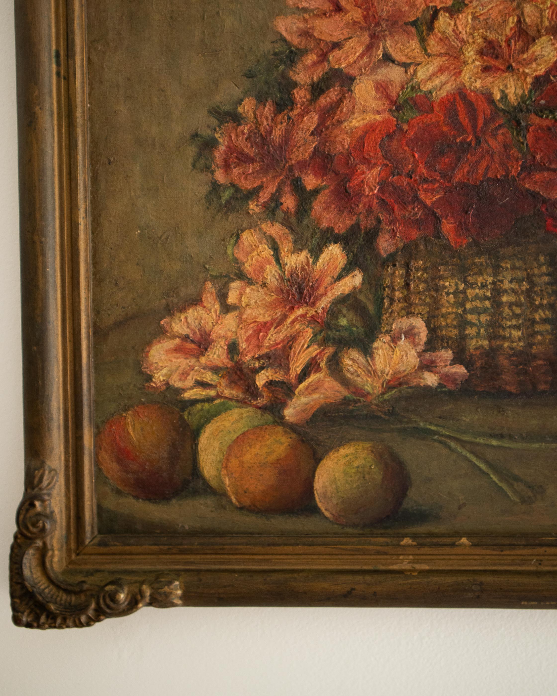 Vintage still life painting with flowers and fruits in a gold frame.