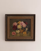 Framed painting of a still life with flowers on a beige wall