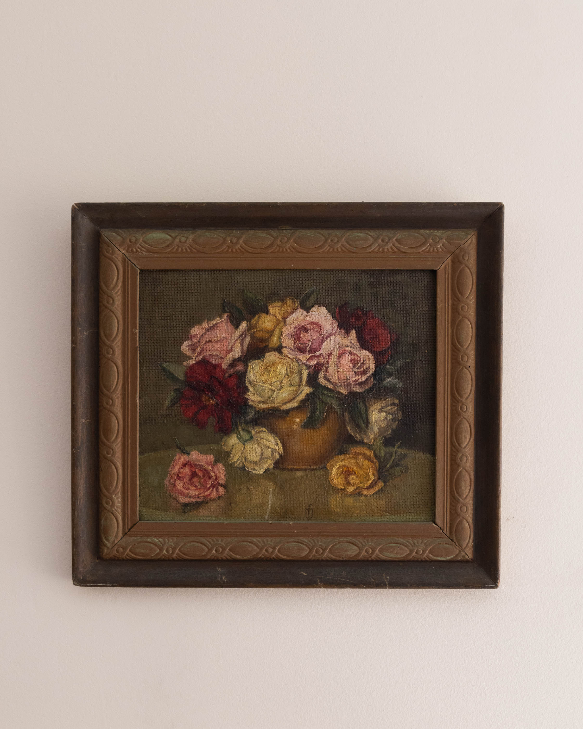 Framed painting of a still life with flowers on a beige wall