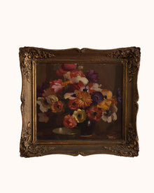 Framed painting of a still life with flowers on a white background