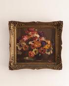 Framed painting of a still life with flowers on a white background
