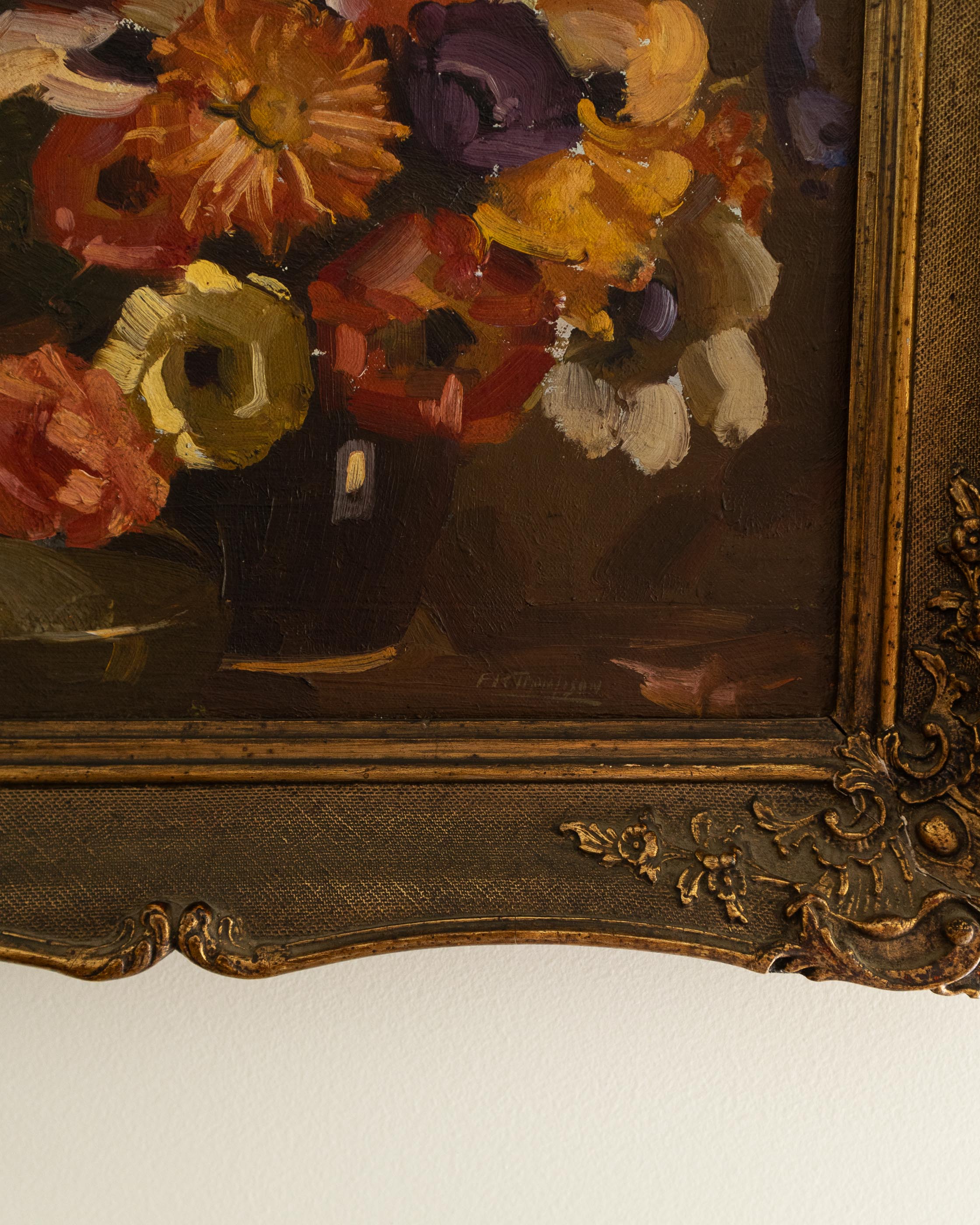 Floral painting with a decorative gold frame on a white background