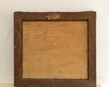 Back of a painting with signature and date, framed in wood.