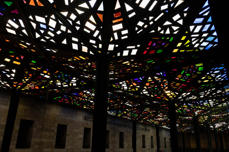Colorful geometric patterned glass roof at the National Gallery of Victoria with a dark background