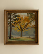 Framed painting of a tree with yellow leaves on a beige wall