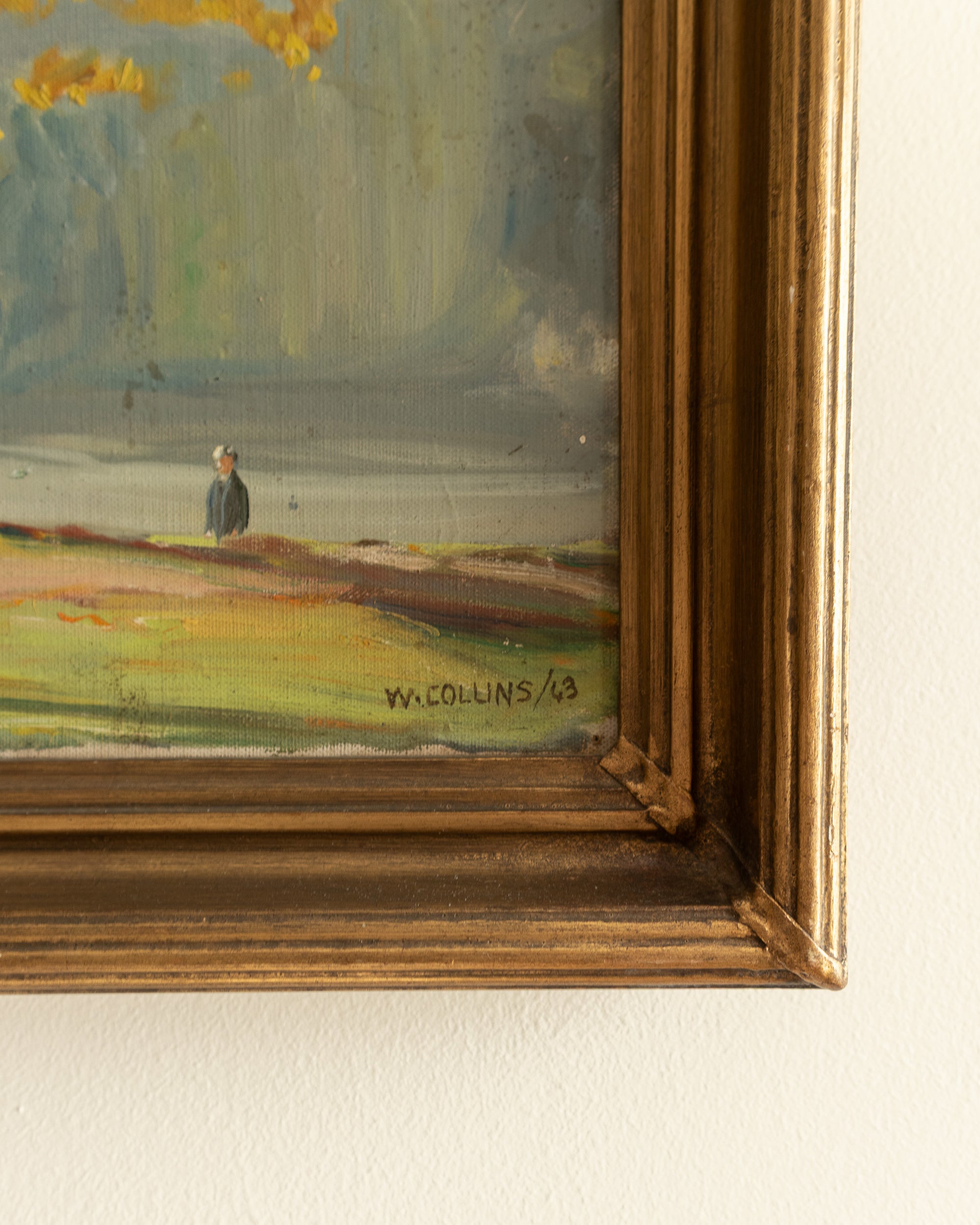 Framed painting of a landscape with a signature on the lower right corner.
