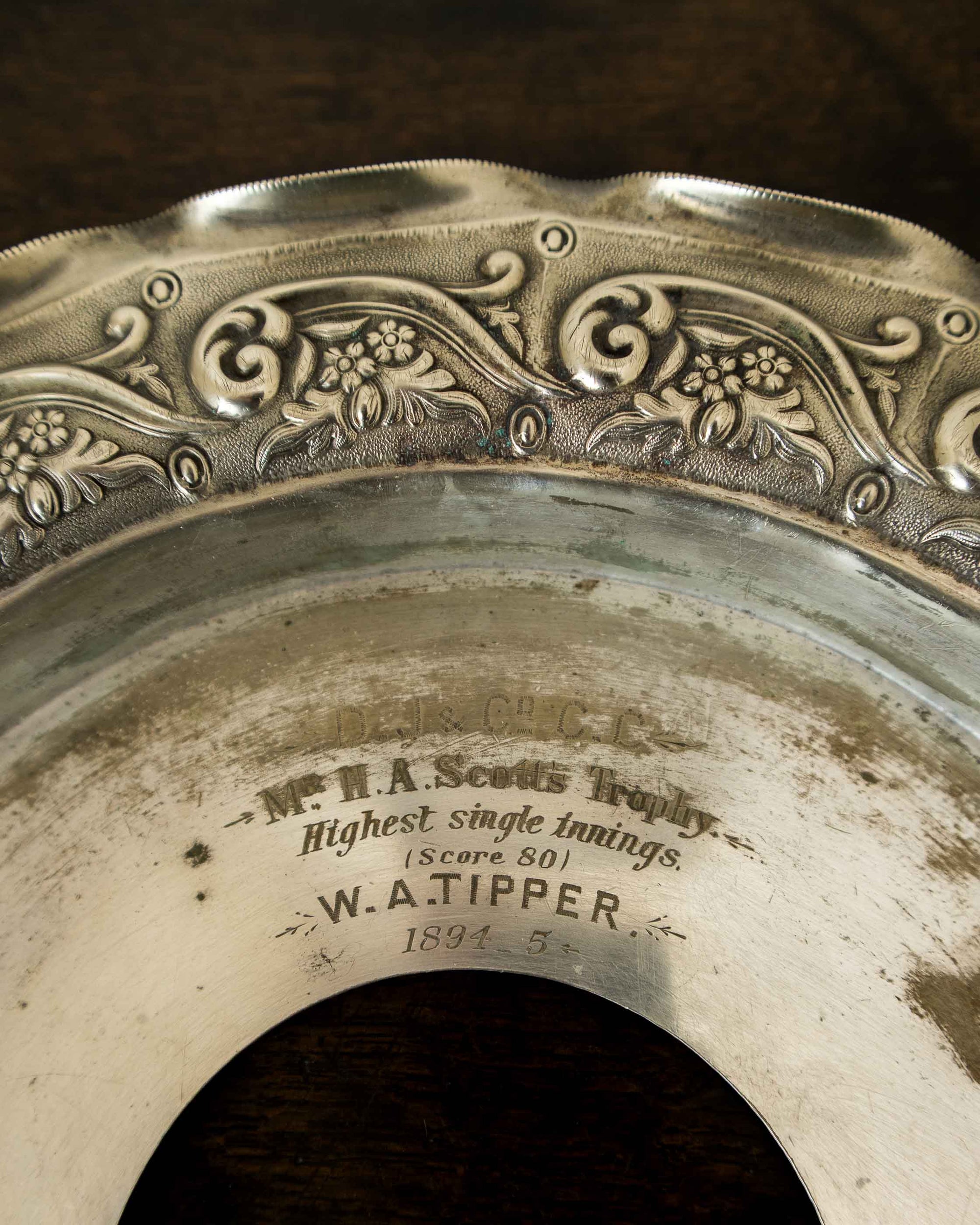 Decorative silver plate with engraved text and patterns
