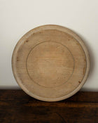 Wooden breadboard on a wooden surface with a white background