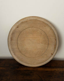 Wooden breadboard on a wooden surface with a white background