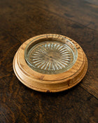 Wooden butter dish with a glass insert on a wooden surface