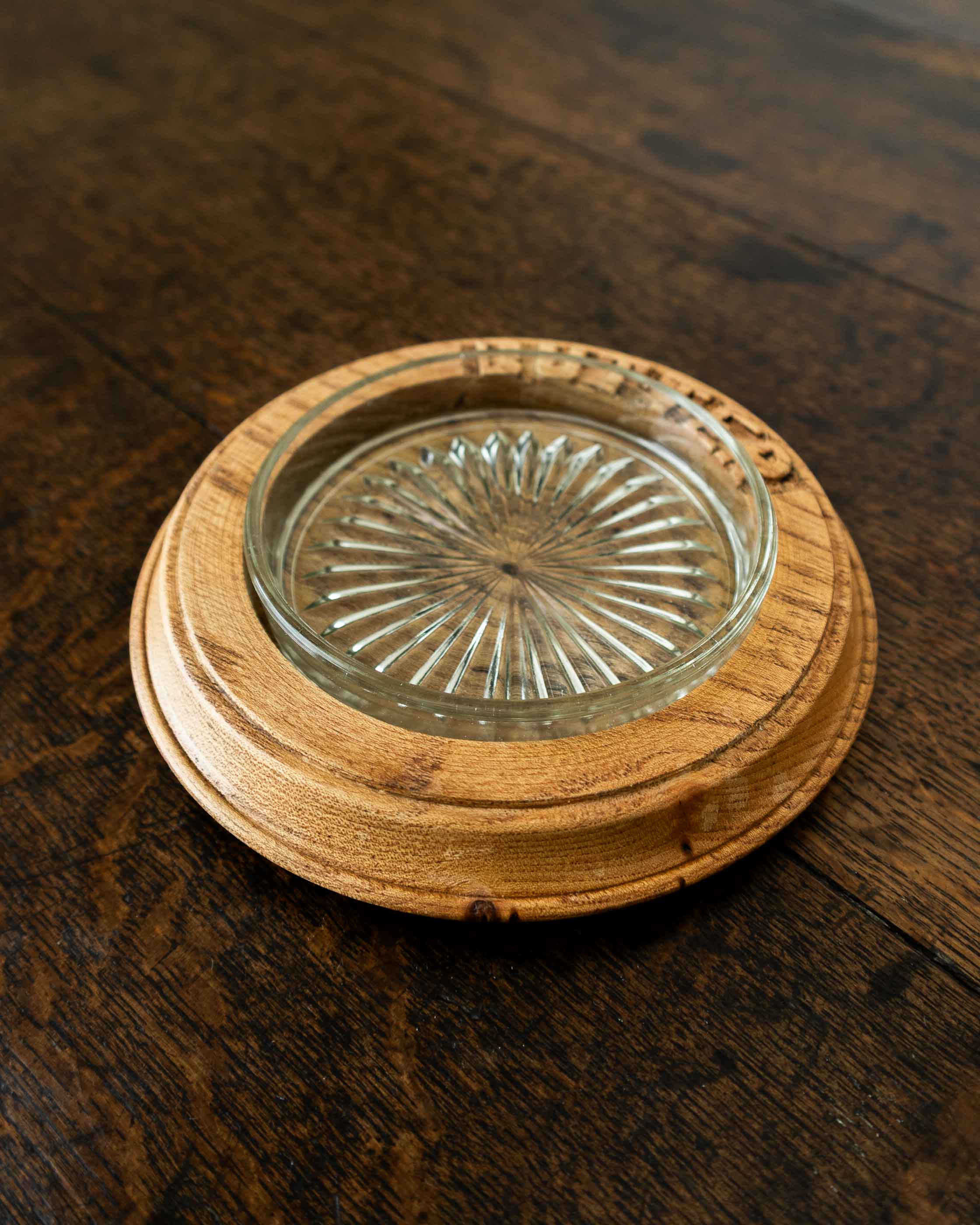 Wooden butter dish with a glass insert on a wooden surface