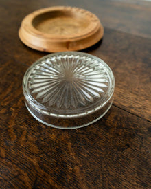 Wooden butter dish with a glass insert on a wooden surface