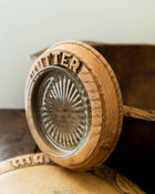 Wooden butter dish with a glass insert on a wooden surface