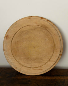 Wooden breadboard on a wooden surface with a white background