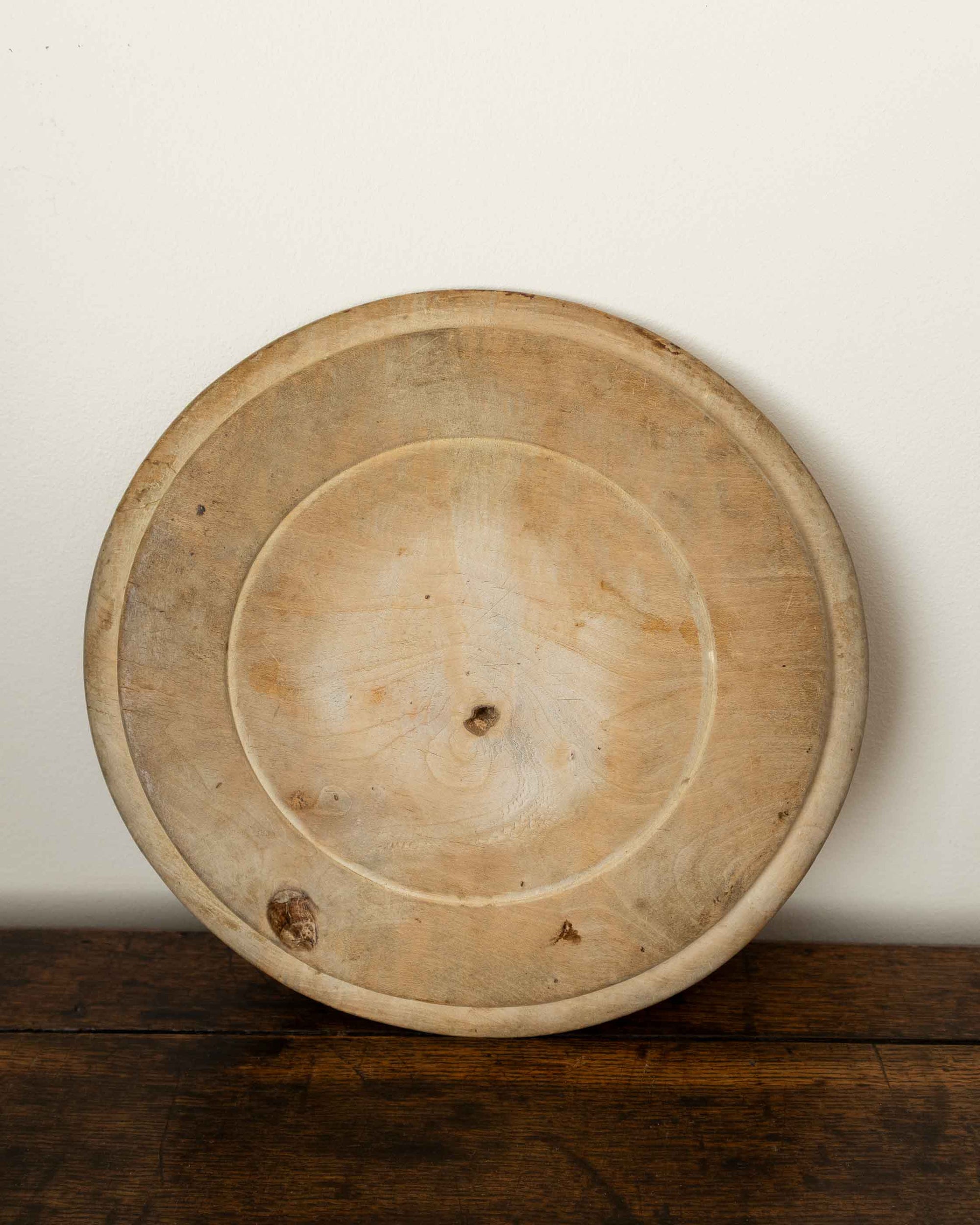 Wooden breadboard on a wooden surface with a white background