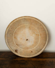 Wooden breadboard on a wooden surface with a white background