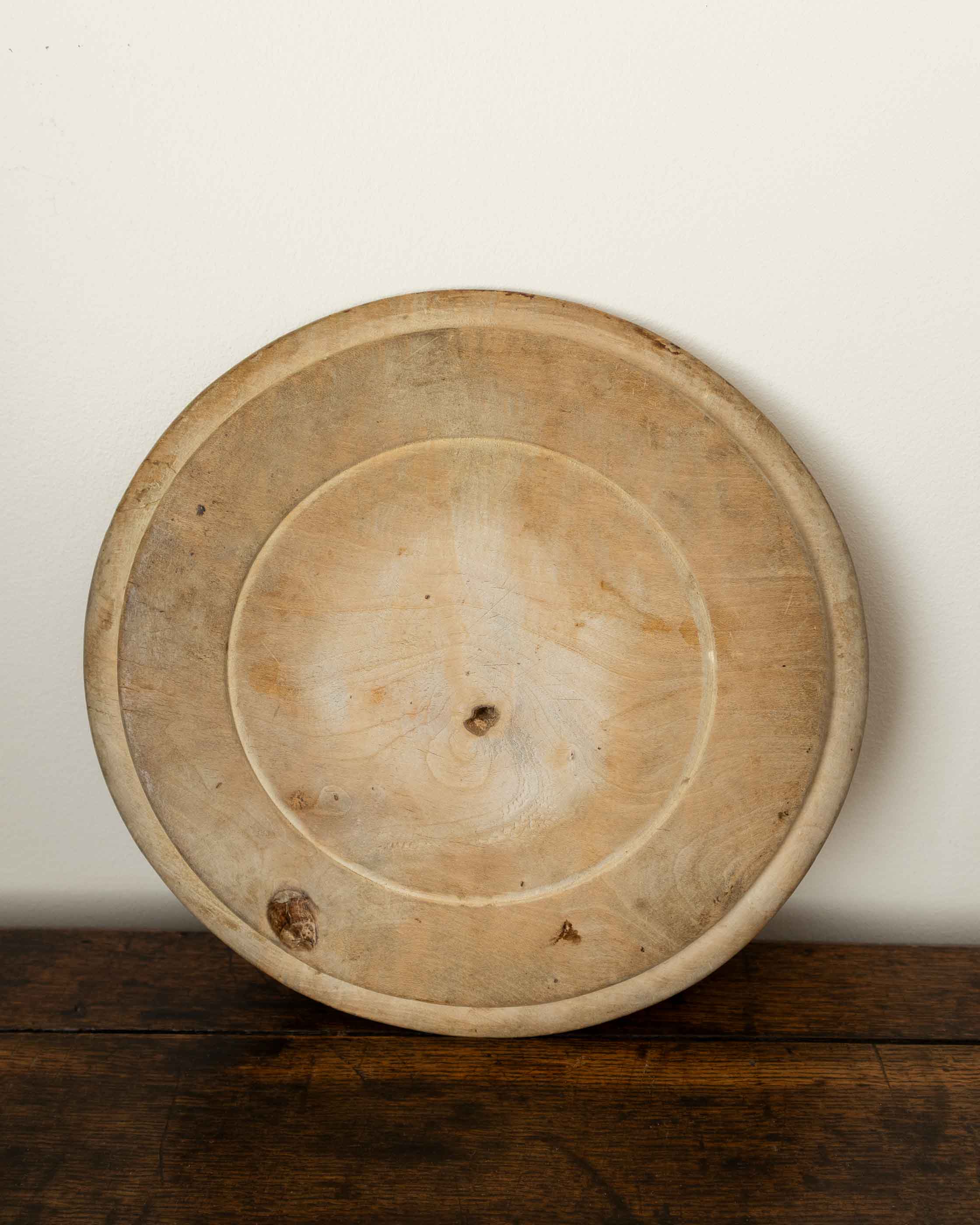 Wooden breadboard on a wooden surface with a white background