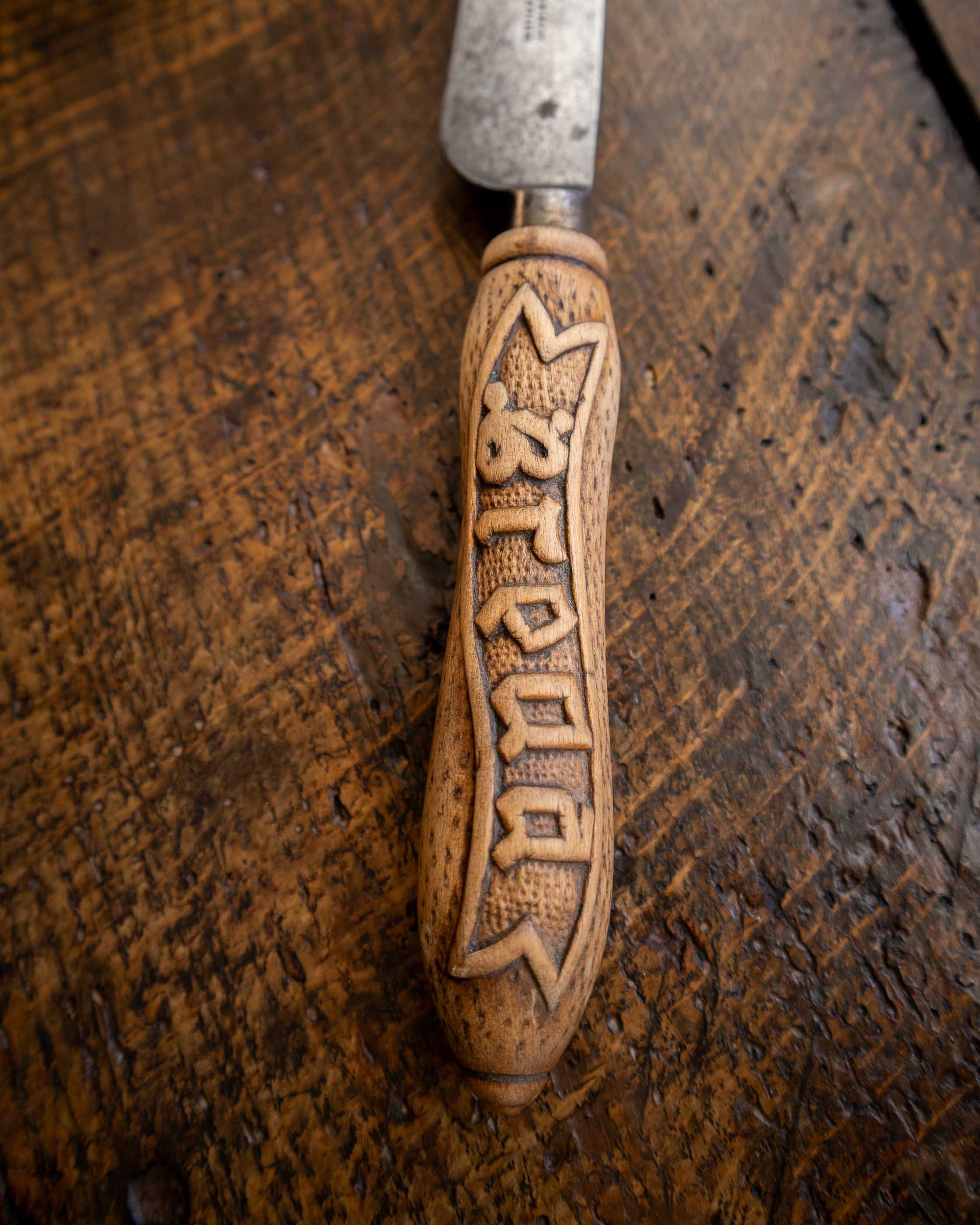 Decorative knife with a wooden handle on a wooden surface