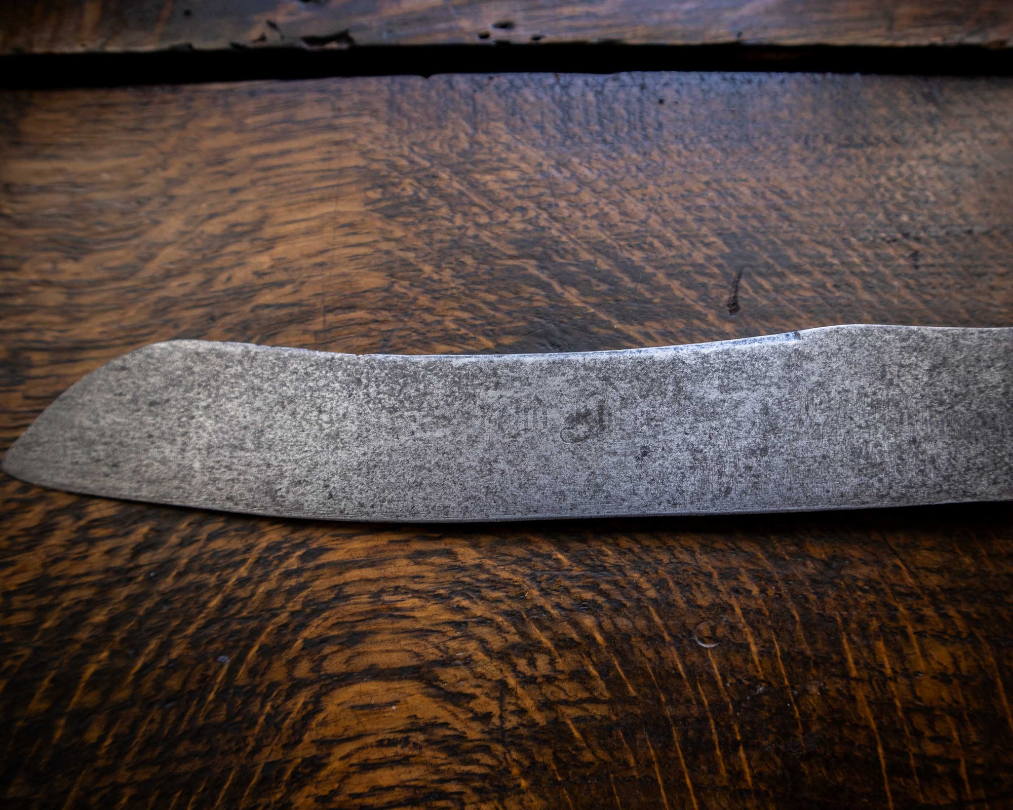 Bread knife blade on a wooden surface